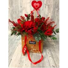 Arrangement in red colors  into ecological bag with hearts.