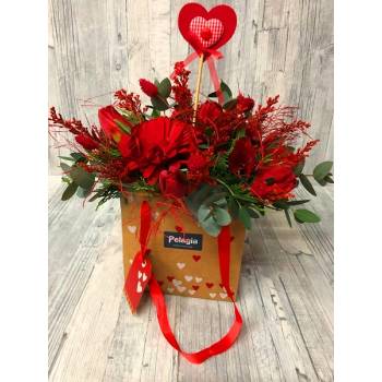 Arrangement in red colors  into ecological bag with hearts.